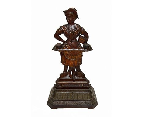 A Coalbrookdale cast iron stick stand, mid 19th century, modelled and cast as a female market seller, on a canted rectangular