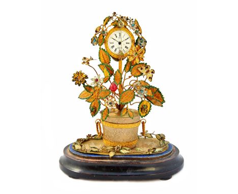 A French novelty brass mantel clock, early 20th century, modelled as a flowering plant and housed under a glass dome, the whi