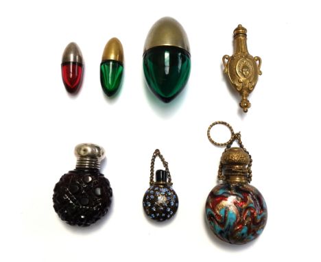 Three coloured glass and metal mounted scent bottles, early 20th century, of egg form, the largest 6.5cm, together with a gil