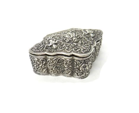 A lozenge shaped trinket box, circa 1900, the hinged cover and the sides embossed with masks and figures amongst foliate scro