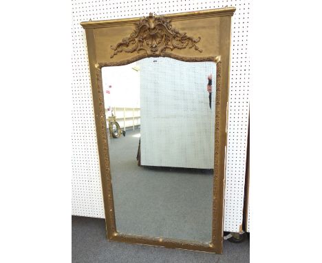 A late 19th century gilt framed wall mirror with shell and scroll crest over bevelled arch top mirror plate, 100cm wide x 172
