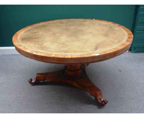 An early 19th century rosewood centre table, the leather inset circular snap top on a turned column, triform platform and thr