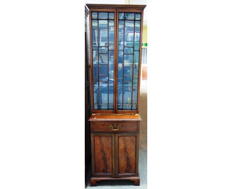 A made-up 19th century bookcase cabinet, the pair of astragal glazed doors over a single drawer and pair of cupboards, on bra
