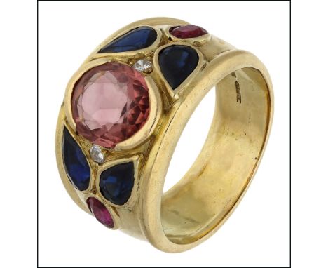 A multi gem set ring, the broad tapered band centred with an oval pink tourmaline flanked by two brilliant-cut diamonds, and 