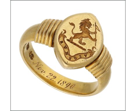 A late 19th century gold signet ring, the marquise-shaped seal engraved with a crest and motto ‘VICIMUS’, between reeded shou