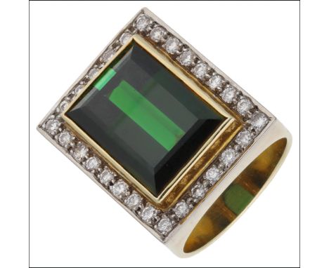 A tourmaline and diamond dress ring, the step-cut green tourmaline within a surround of brilliant-cut diamonds, to a broad ta