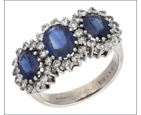 A sapphire and diamond dress ring, designed as a triple cluster, each set with an oval-cut sapphire within a surround of bril