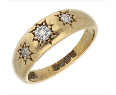 A diamond three stone ring, 1915, set with a graduated row of old brilliant-cut diamonds, with engraved stars to each setting