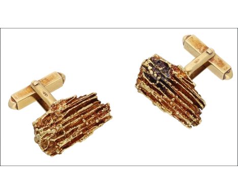 A pair of 18ct gold ‘nugget’ cufflinks by Gilian Packard, 1969, the textured irregular nugget panels on rigid mounts, the swi