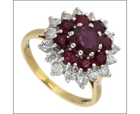 A ruby and diamond cluster ring, 1979, set with a central circular-cut ruby within a surround of rubies and outer border of b