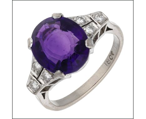 An amethyst and diamond ring, the oval-cut amethyst claw set between trios of brilliant-cut diamonds, stamped ‘18CT’, ring si