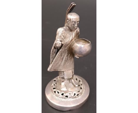 A Burmese silver coloured metal menu holder, in the form of a figure, 2.3 ozt, 7 cm high
