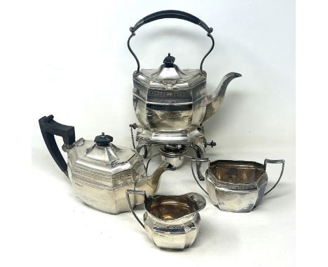 A silver four piece tea set, with engraved decoration, Sheffield 1928, 69.4 ozt (all in), the kettle, stand and burner with a
