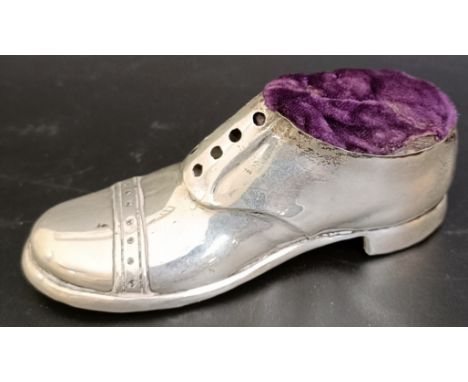 A silver pin cushion in the form of a boot, Birmingham 1913, 13 cm wide