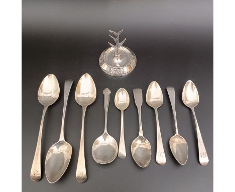 Assorted silver spoons and a ring stand