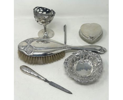 A silver backed brush, a pierced dish, a heart shaped box, with a silver lid a cased glass, and a file (5)