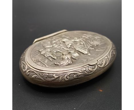 A 19th century Dutch silver coloured metal oval snuff box, lid embossed with interior scene, 6.5 cm wide, 39 g
