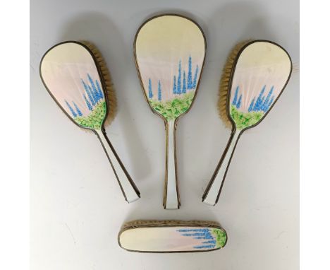 A George V silver and enamel part dressing table set, with floral decoration, London 1937