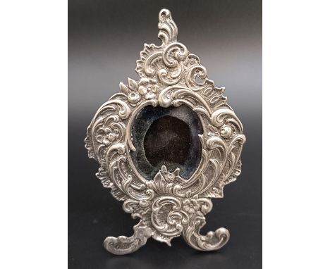 An ornate silver photograph frame, 13 cm high