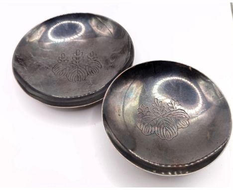 A Japanese silver pin dish, with engraved decoration, 9 cm diameter, and another, 7.5 cm diameter, 2.7 ozt (2)