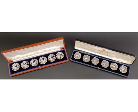 A set of six Art Nouveau silver buttons, decorated Iris, cased, and another similar set (2)