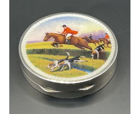 A silver and enamel compact, decorated horses, import marks for London 1929, 5 cm diameter