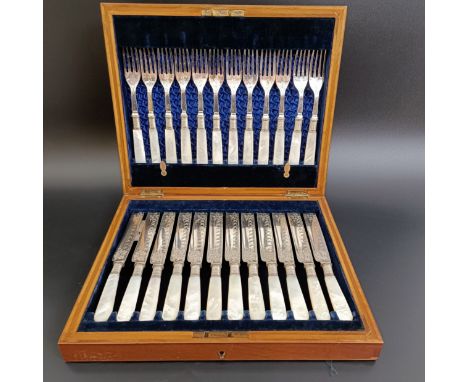 A set of twelve silver plated and mother of pearl dessert eaters, in a walnut case