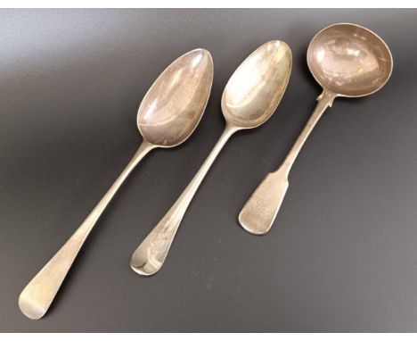 A George III silver Old English pattern serving spoon, another, and a fiddle pattern ladle, various dates and marks, 5.6 ozt
