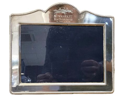 An Elizabeth II silver photograph frame, engraved 'Newmarket Racecourses The Home Of Racing' aperture 17 x 12 cm, with frame,