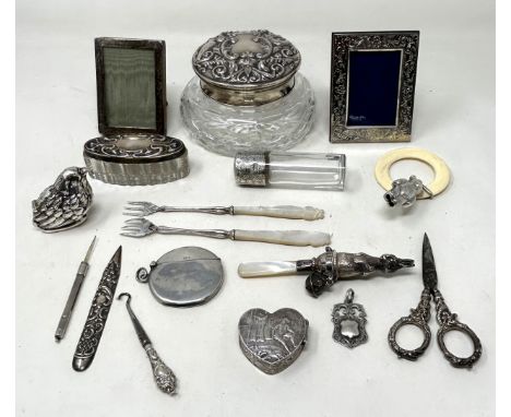 A silver child's rattle, in the form of a rabbit, Birmingham 1935, another teddy bear rattle, a silver heart shaped box, and 