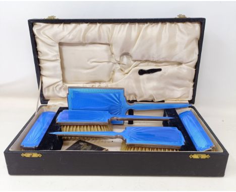 A silver and blue enamel dressing table set, Birmingham 1914/15, cased
