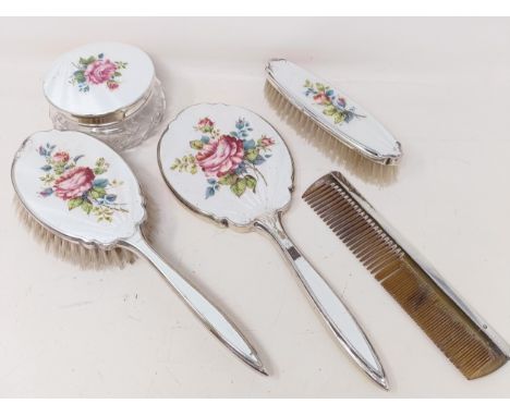 A George V cut glass dressing table box, with a silver and enamel lid, a matching mirror, a brush and a comb (4)