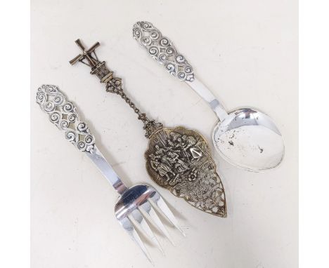 A pair of Norwegian silver coloured metal servers, David Andersen, and a Dutch silver coloured metal spoon with a windmill fi