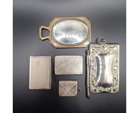 A George V silver matchbox holder, a silver cased notebook, a small hand mirror, a stamp box in the form of an envelope, and 
