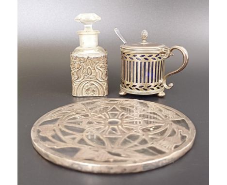 A silver and glass coaster, Birmingham 1934, a silver mustard pot with a blue glass liner, a perfume bottle with a silver pla