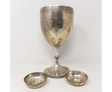 A large Victorian silver goblet, with engraved decoration, named and dated 1870, London 1869, 22.5 cm high, and a small pair 