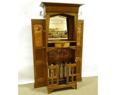 An impressive Liberty &amp; Co Art Nouveau oak hall stand, circa 1910, with impressed copper panels, central bevel-glass mirr