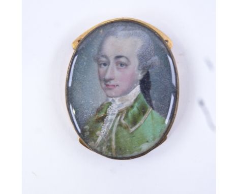 A Georgian miniature watercolour on ivory, head and shoulders portrait of a gentleman wearing a green coat, mounted in origin