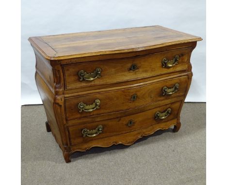 An 18th century Italian fruitwood 3-drawer bombe commode, with shaped drawer fronts, carved panelled corners on carved base, 