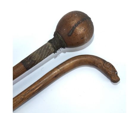 A hardwood Tribal club with metal wirework-bound handle, length 80cm, and a walking stick with carved dogs-head handle (2)Som