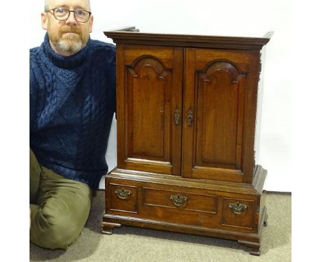 A Georgian mahogany collector's cabinet of small size, with 2 fielded arch panelled doors enclosing drawer fitted interior, r