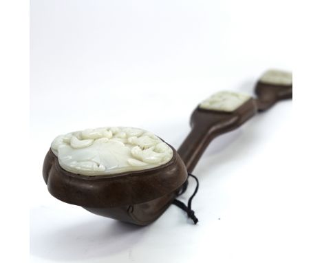 A Chinese hardwood rui sceptre with 3 inset relief carved jade panels, length 50cm, largest jade panel 10cm acrossAll in very