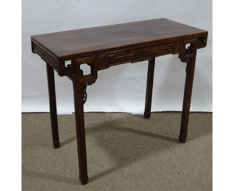 A 19th century Chinese hardwood altar table with relief carved frieze, central frieze drawer raised on square legs, 98cm x 48