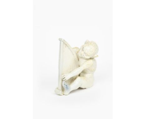 A Martin Brothers Pottery stoneware Imp Musician by Robert Wallace Martin, modelled seated playing the harp, covered in a whi