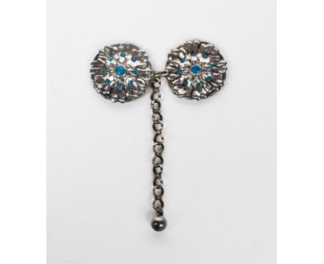 A silver and enamel cloak clasp by Bertha Lillian Goff, two silver flowerhead panels with turquoise blue enamel details, with
