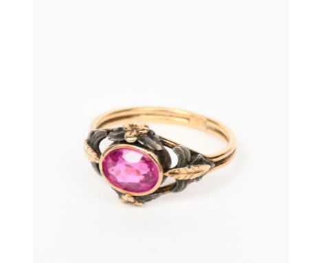 A gold and synthetic ruby ring, the openwork shoulder with foliate panels in silver and gilt, set with synthetic ruby, unsign