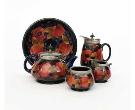 Pomegranate a Moorcroft Pottery and Tudric Pewter tea set designed by William Moorcroft, for retail by Liberty &amp; Co, comp