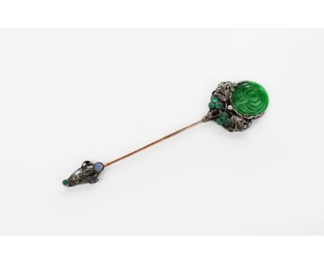 A jade set silver stick pin probably by Bernard Instone, the pin with pierced and cast foliate frame set with six small chrys