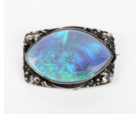 A Rhoda Wager silver mounted opal brooch, the rectangular frame with leaf and berry design, with brooch clip and hanging loop