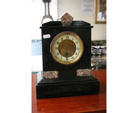 A black slate mantle clock with marble motifs.